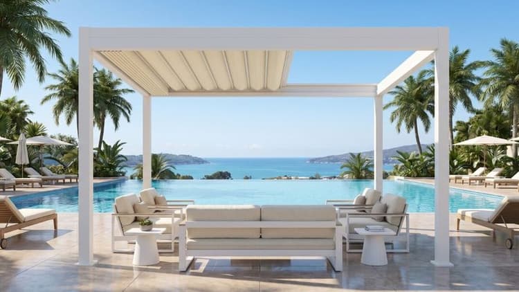 White retractable fabric pergola overlooking an infinity pool with ocean views and outdoor lounge seating.